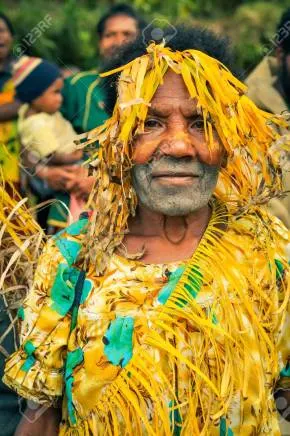 56611157-kubor-range-papua-new-guinea-july-2015-native-woman-with-white-colour-on-face-is-covered-in-yellow-s.jpg